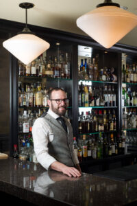 Portrait of a classically dressed bartender by Nick Perry