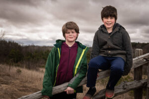Two boys in a field photo Example by Nick Perry Photography