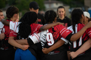 Girls rugby team huddle