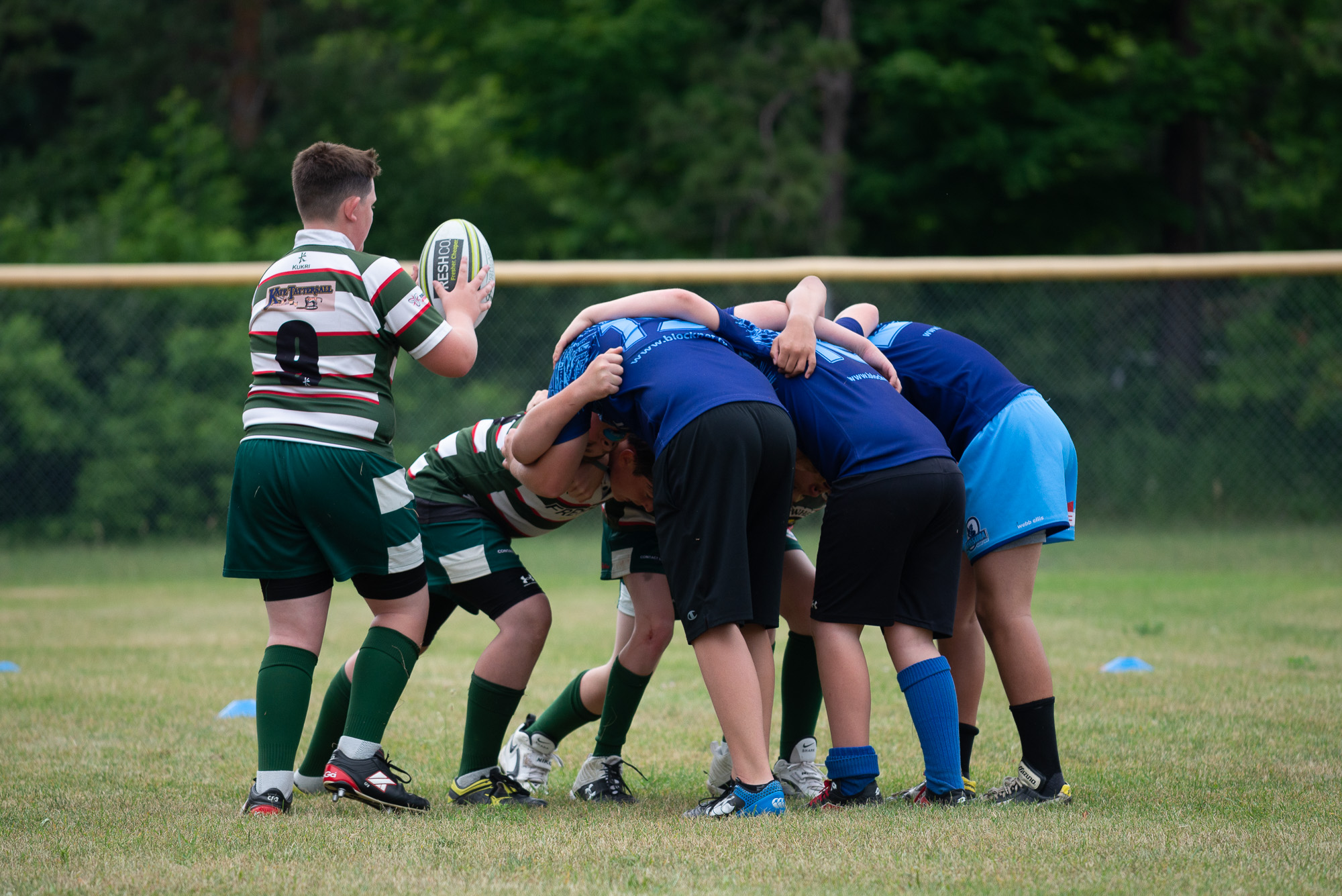 Young rugby players in a scrum