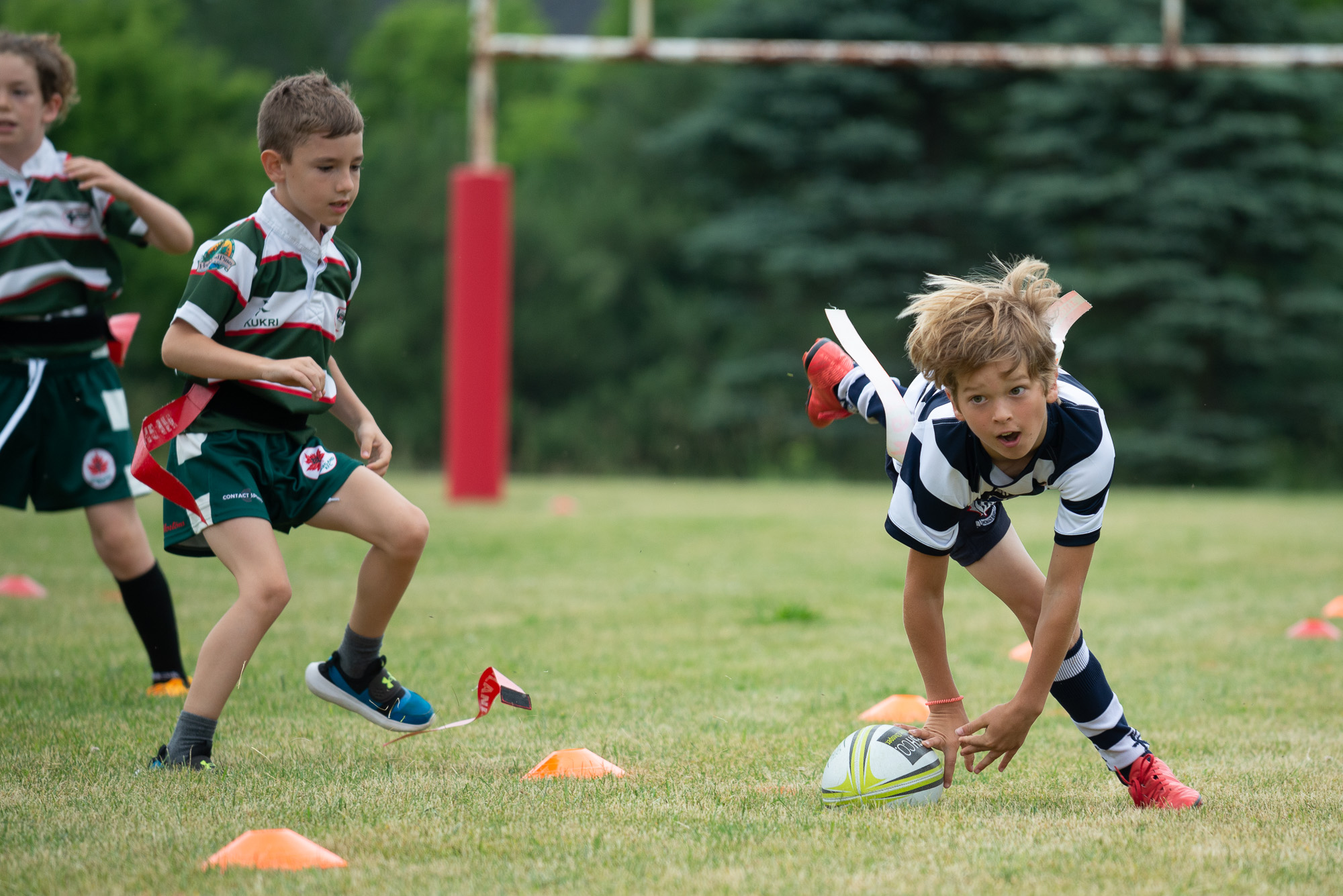 Young male rugby player running with the ball