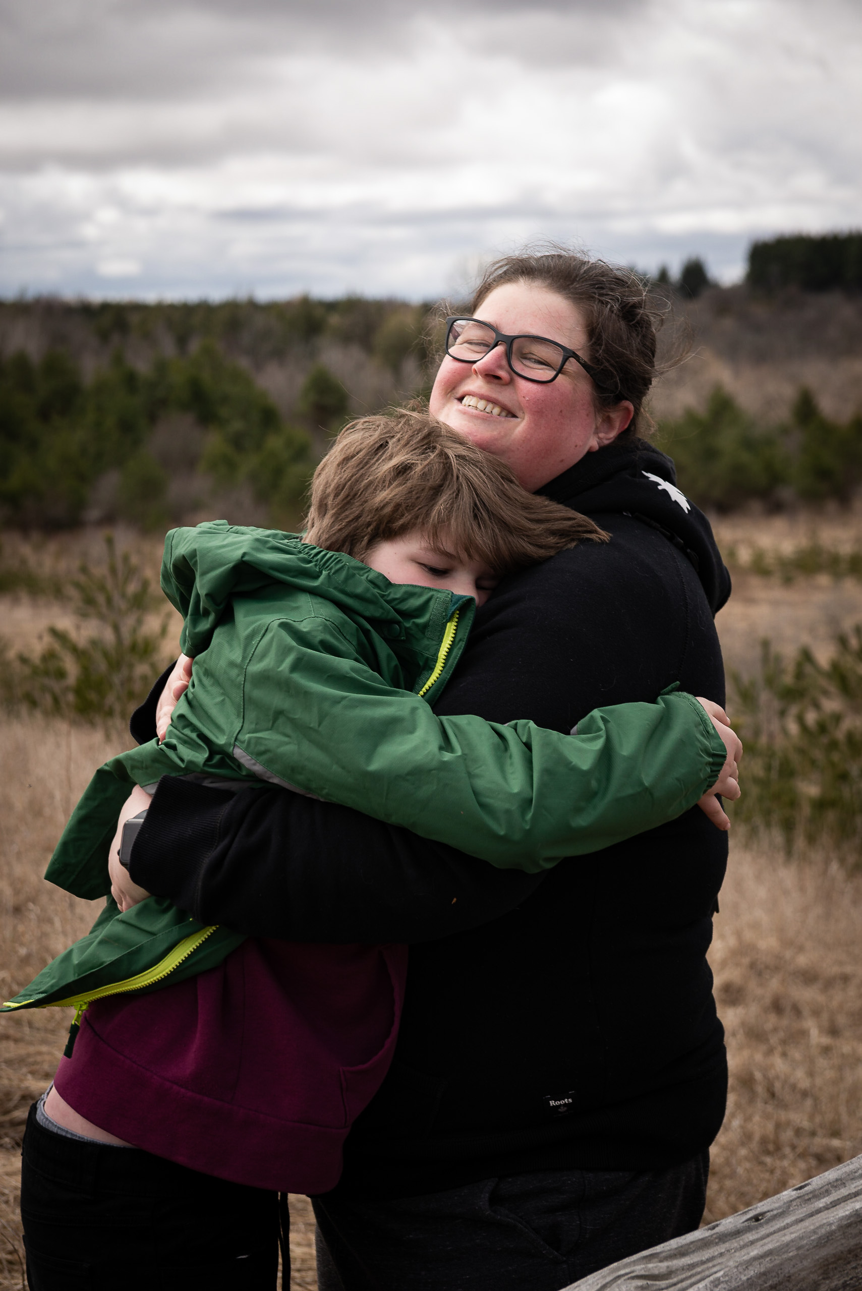Mom hugging son as Nashville Conservation Reserve in Caledon